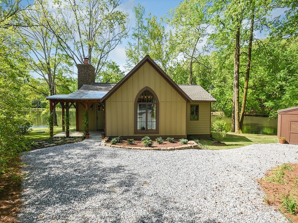 Mountain style one-story wood exterior home photo in Other with a shingle roof