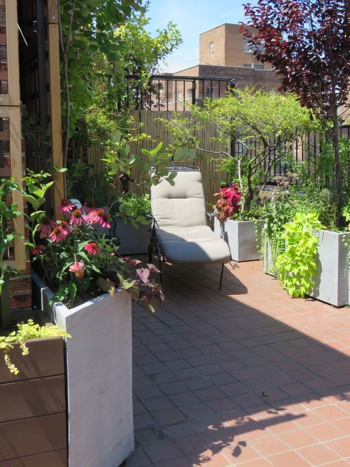 Design ideas for a mid-sized traditional courtyard patio in New York with a vertical garden, tile and no cover.