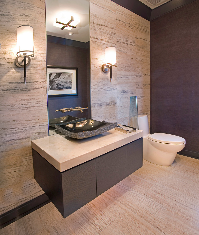 Inspiration for a small contemporary powder room in Denver with a vessel sink, flat-panel cabinets, grey cabinets, a one-piece toilet, beige tile, porcelain tile, beige walls, porcelain floors, engineered quartz benchtops, beige floor and beige benchtops.