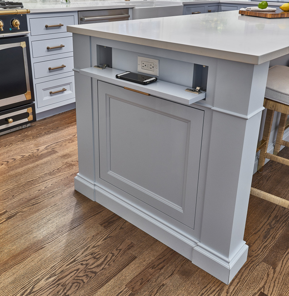Example of a mid-sized classic l-shaped medium tone wood floor and brown floor kitchen pantry design in Chicago with a farmhouse sink, recessed-panel cabinets, blue cabinets, quartz countertops, white backsplash, marble backsplash, colored appliances, an island and white countertops