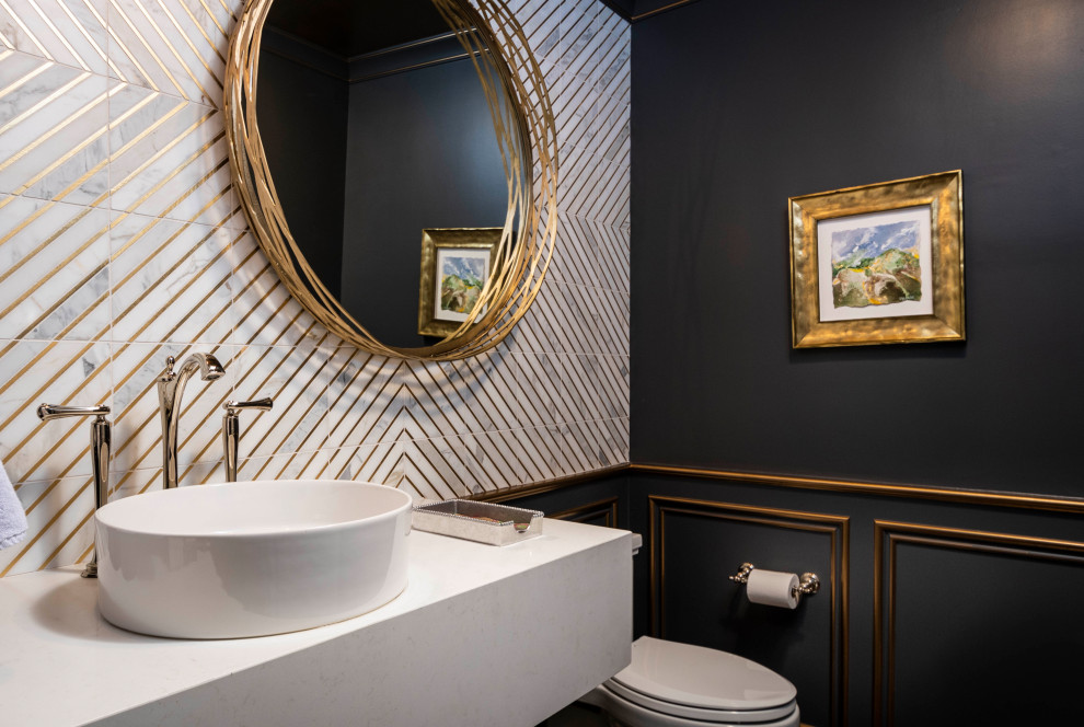 Small traditional powder room in Indianapolis with white cabinets, a one-piece toilet, white tile, marble, blue walls, medium hardwood floors, a vessel sink, engineered quartz benchtops, brown floor, white benchtops, a floating vanity and panelled walls.