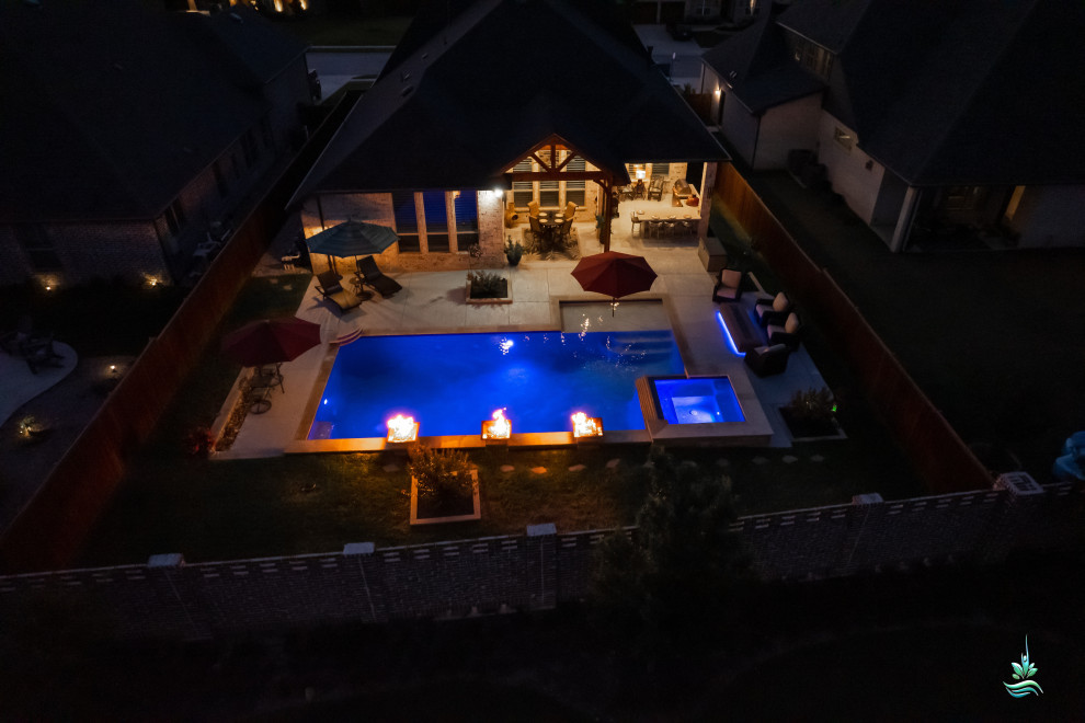 Modelo de piscinas y jacuzzis naturales vintage grandes a medida en patio trasero con losas de hormigón
