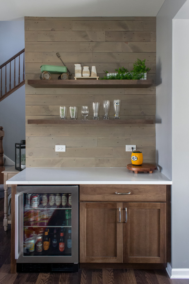 This is an example of a mid-sized transitional single-wall home bar in Chicago with no sink, shaker cabinets, brown splashback and shiplap splashback.