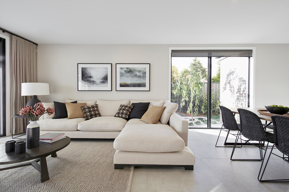 This is an example of a mid-sized contemporary open concept living room in Canberra - Queanbeyan with beige walls, porcelain floors, no fireplace and grey floor.