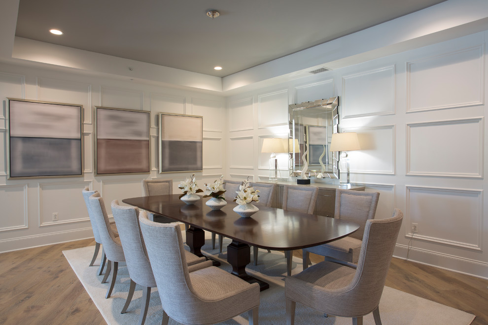 Example of a large transitional dark wood floor and brown floor enclosed dining room design in DC Metro with white walls and no fireplace