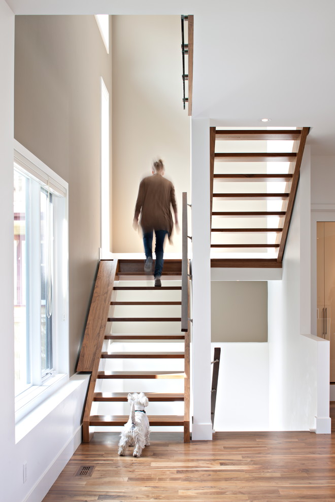 Inspiration for a contemporary wood u-shaped staircase in Calgary with open risers.