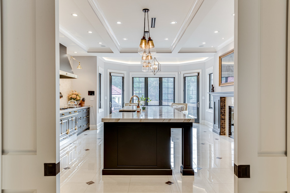 Example of a large transitional marble floor and beige floor eat-in kitchen design in Baltimore with an undermount sink, recessed-panel cabinets, black cabinets, quartz countertops, black appliances, an island and beige countertops