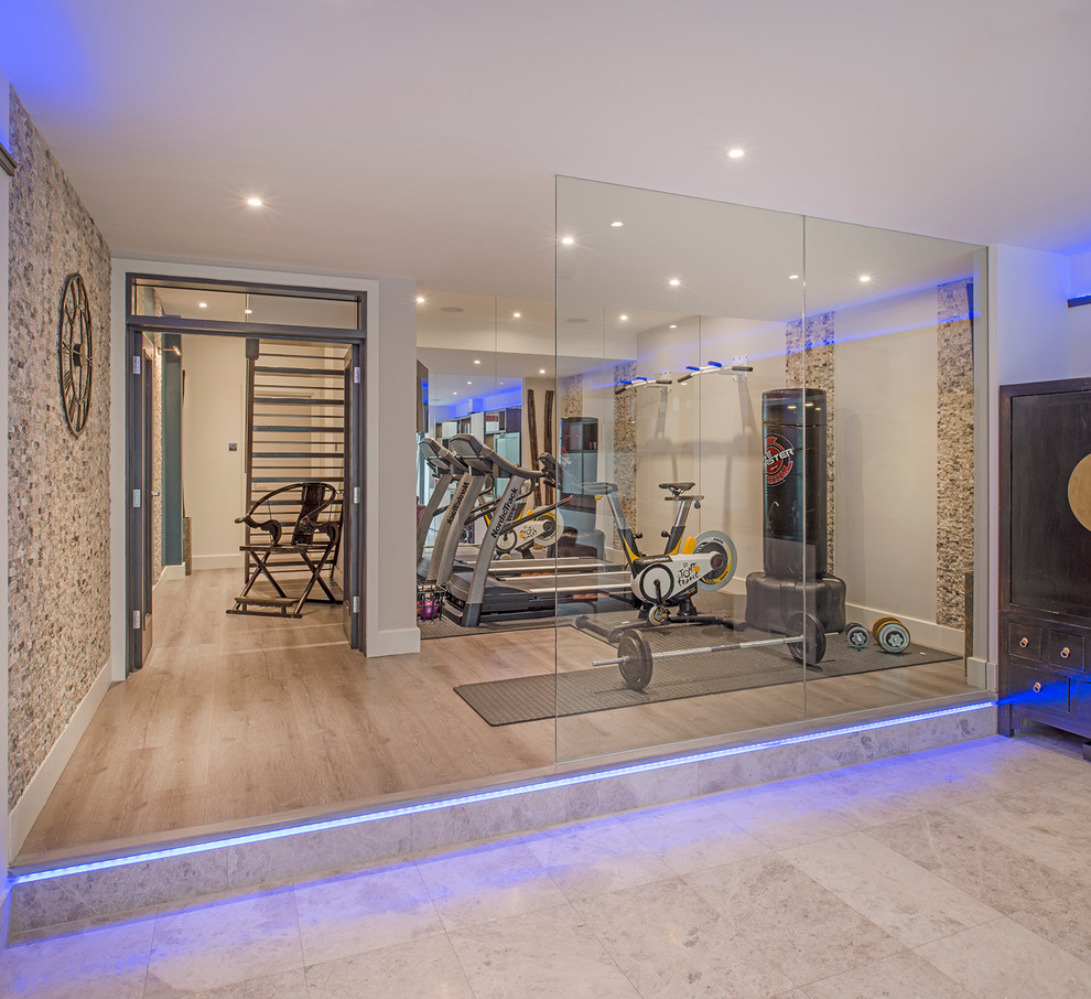 Inspiration for a mid-sized contemporary multipurpose gym in London with beige walls, light hardwood floors and beige floor.