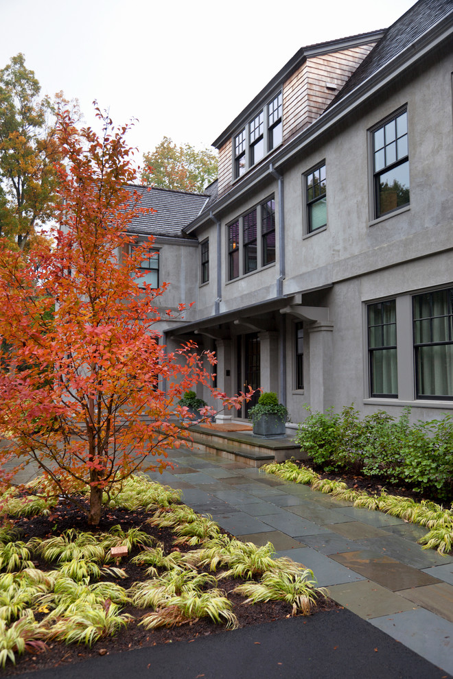 This is an example of a traditional front yard garden for fall in Boston with natural stone pavers.