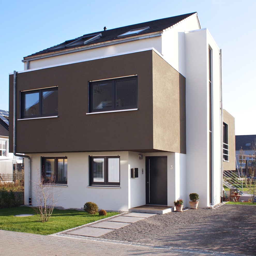 Photo of a large contemporary three-storey white exterior in Other with a gable roof.