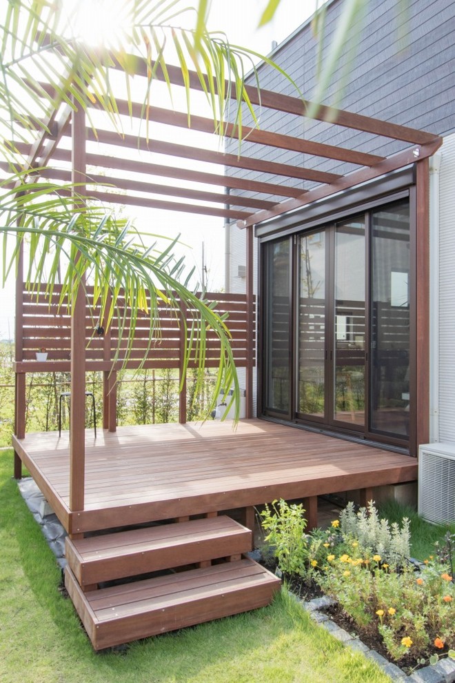 Design ideas for a scandinavian side yard deck in Other with an outdoor kitchen and a pergola.