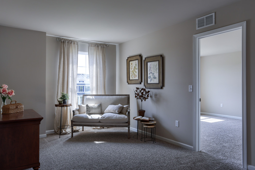 Large transitional carpeted and beige floor hallway photo with beige walls