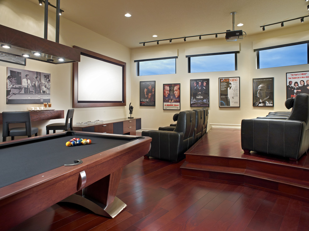 This is an example of a contemporary home theatre in Detroit with white walls and red floor.