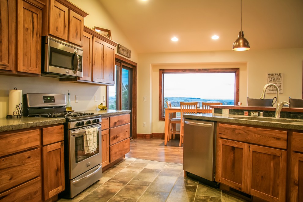 Open concept kitchen - mid-sized rustic l-shaped open concept kitchen idea with medium tone wood cabinets, concrete countertops, stainless steel appliances and an island