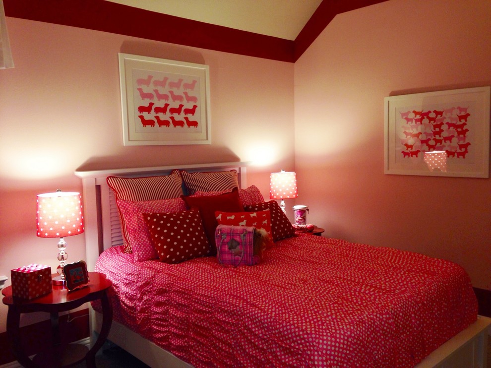 This is an example of a mid-sized transitional kids' bedroom for kids 4-10 years old and girls in Indianapolis with pink walls and carpet.