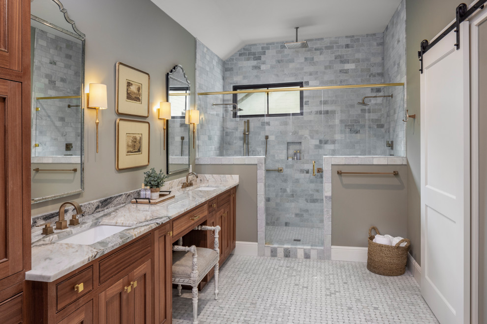 This is an example of a mid-sized traditional bathroom in Austin with a freestanding tub and gray tile.