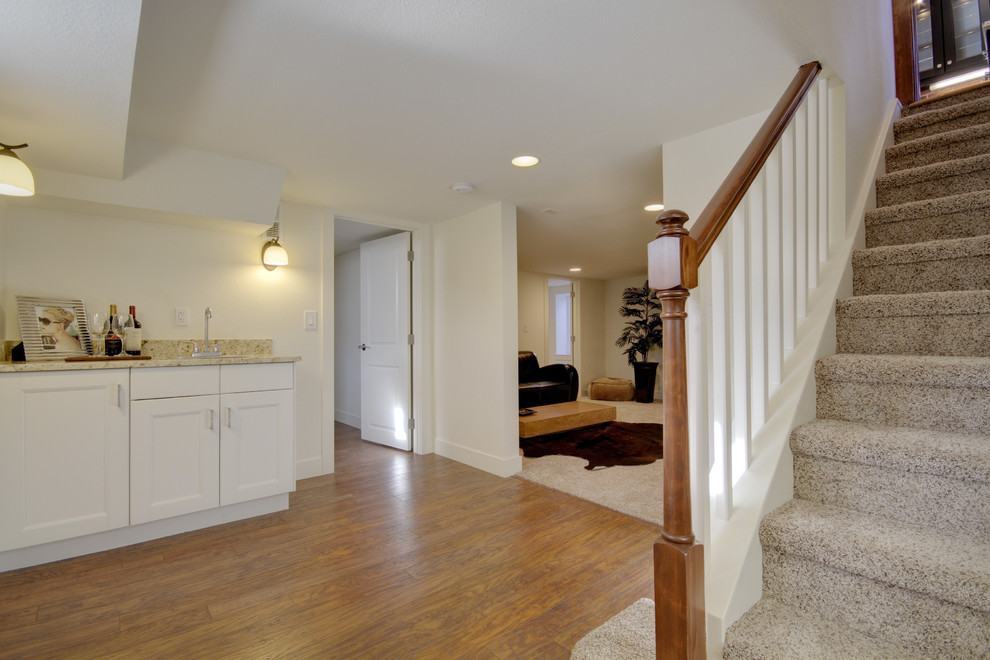 Design ideas for a mid-sized eclectic basement in Denver with medium hardwood floors and brown floor.