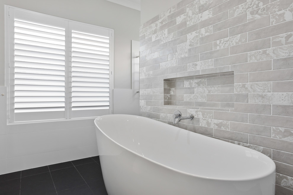 Mid-sized beach style master bathroom in Perth with shaker cabinets, white cabinets, a freestanding tub, an open shower, white tile, porcelain tile, white walls, porcelain floors, a drop-in sink, marble benchtops, grey floor and white benchtops.