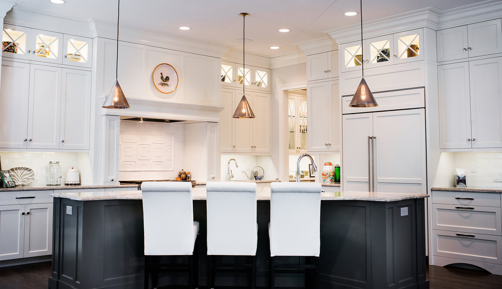 Inspiration for a large transitional l-shaped eat-in kitchen in Denver with white cabinets, white splashback, panelled appliances, dark hardwood floors, with island and shaker cabinets.
