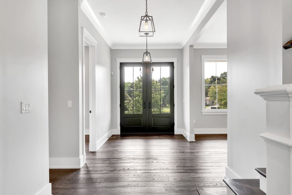 Photo of a large farmhouse foyer in Other with grey walls, dark hardwood flooring, a double front door, a dark wood front door and brown floors.
