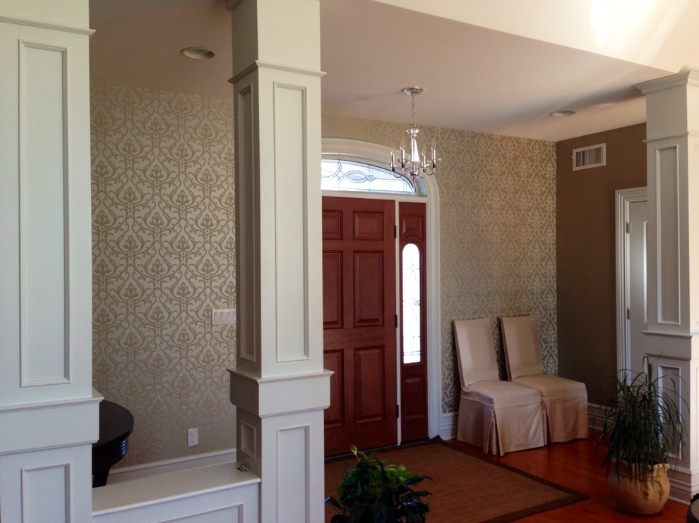 This is an example of a mid-sized transitional foyer in Other with metallic walls, medium hardwood floors, a single front door, a brown front door, brown floor and wallpaper.