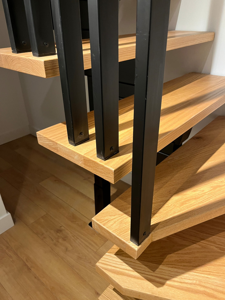 Staircase - large industrial wooden l-shaped metal railing staircase idea in Vancouver with metal risers