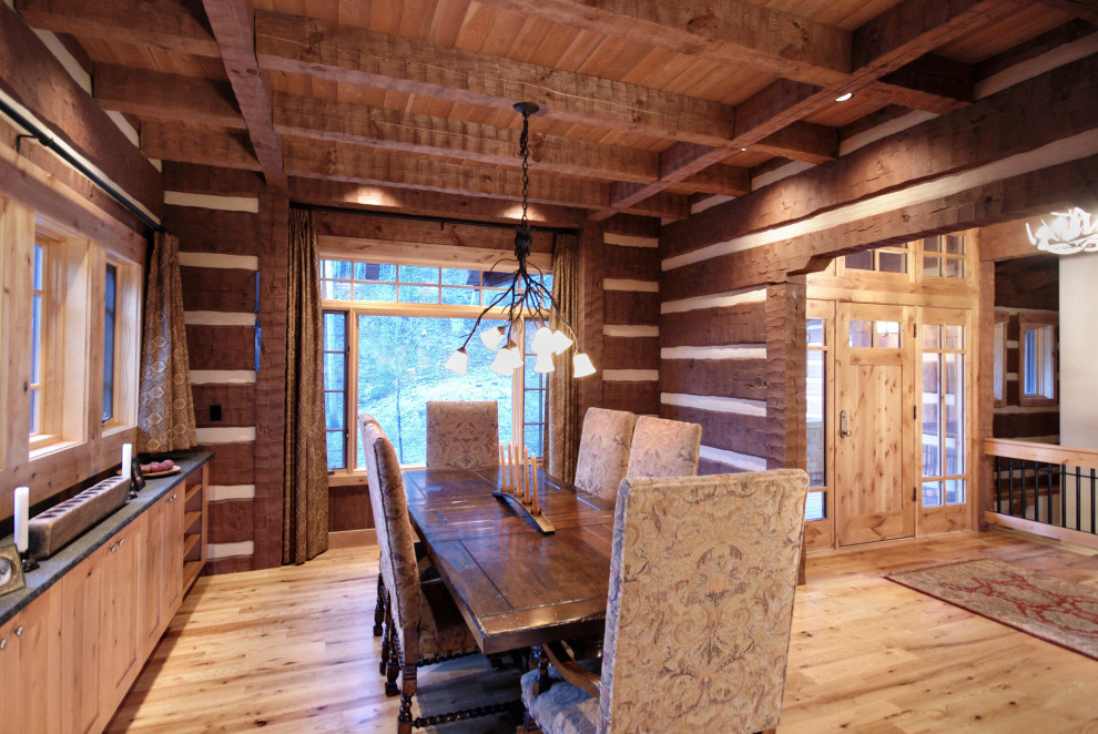 Inspiration for a mid-sized rustic light wood floor and exposed beam enclosed dining room remodel with brown walls