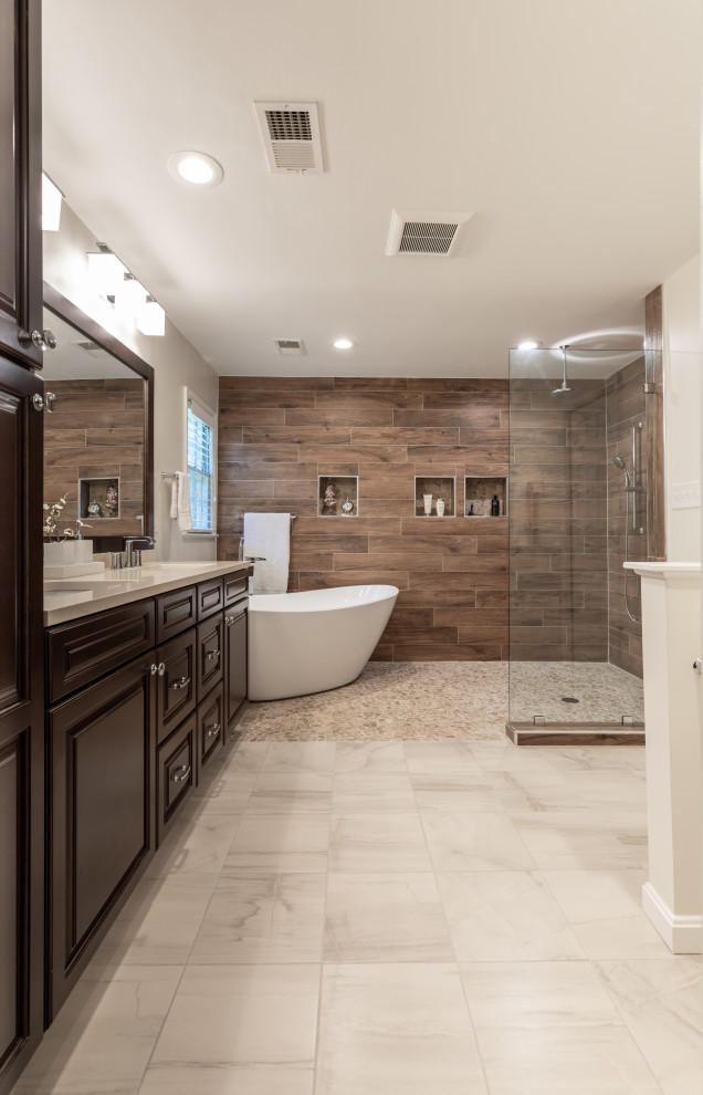 Inspiration for a mid-sized contemporary master bathroom in DC Metro with brown cabinets, a freestanding tub, a shower/bathtub combo, a one-piece toilet, brown tile, grey walls, an undermount sink, grey floor, an open shower, white benchtops, a double vanity and a built-in vanity.