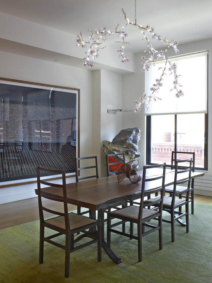 This is an example of a contemporary dining room in Los Angeles with white walls and dark hardwood floors.