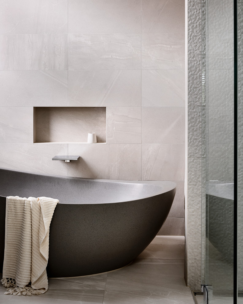This is an example of a large contemporary master bathroom in Melbourne with flat-panel cabinets, dark wood cabinets, a freestanding tub, a corner shower, a wall-mount toilet, gray tile, ceramic tile, grey walls, ceramic floors, a drop-in sink, wood benchtops, grey floor, a hinged shower door and brown benchtops.