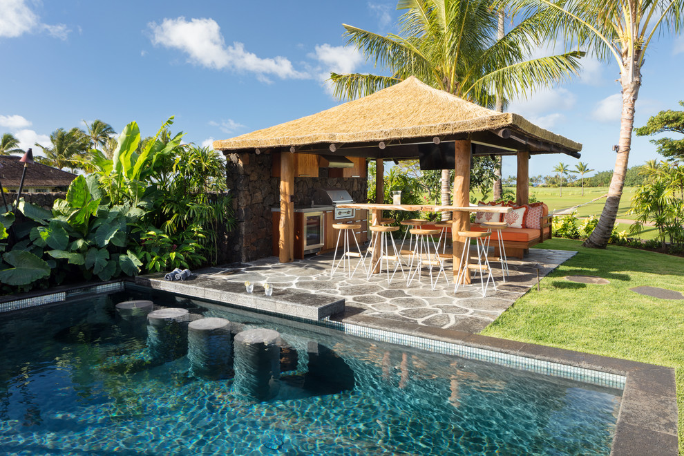 Photo of an expansive beach style backyard patio in Hawaii with an outdoor kitchen, natural stone pavers and a gazebo/cabana.