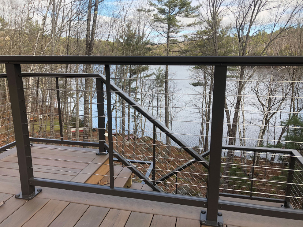 Transitional deck in Portland Maine with metal railing.