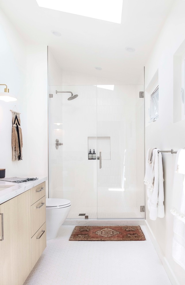 Design ideas for a mid-sized scandinavian 3/4 bathroom in San Francisco with flat-panel cabinets, light wood cabinets, an alcove shower, white tile, subway tile, white walls, mosaic tile floors, an undermount sink, white floor, a hinged shower door, quartzite benchtops and grey benchtops.