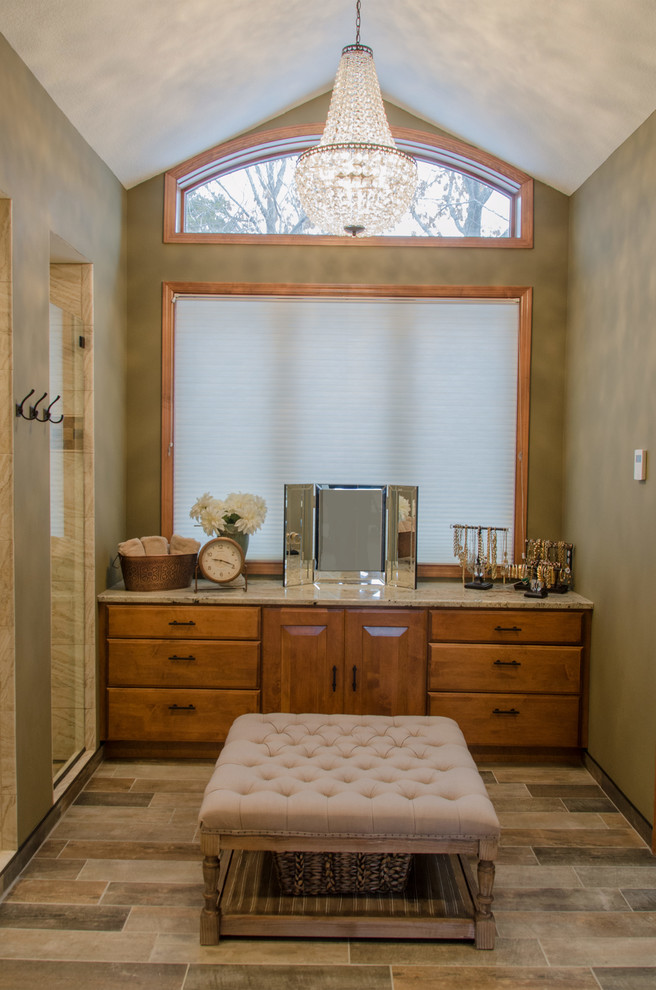 Large contemporary master bathroom in Minneapolis with furniture-like cabinets, medium wood cabinets, an open shower, a one-piece toilet, beige tile, travertine, beige walls, porcelain floors, an undermount sink, granite benchtops, brown floor and an open shower.