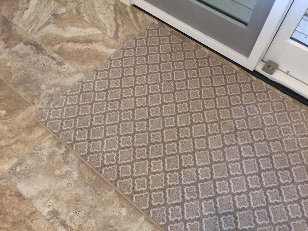 Example of a mid-sized transitional u-shaped porcelain tile kitchen design with white cabinets, marble countertops, stainless steel appliances and an island