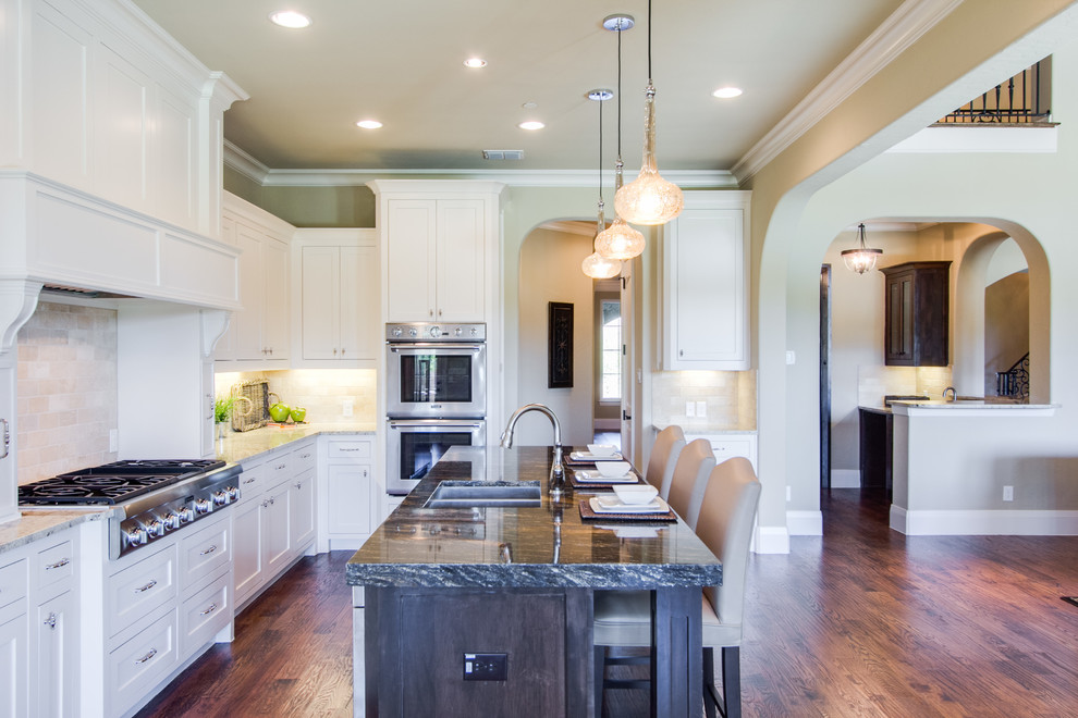Photo of a large transitional kitchen in Dallas with medium hardwood floors and brown floor.