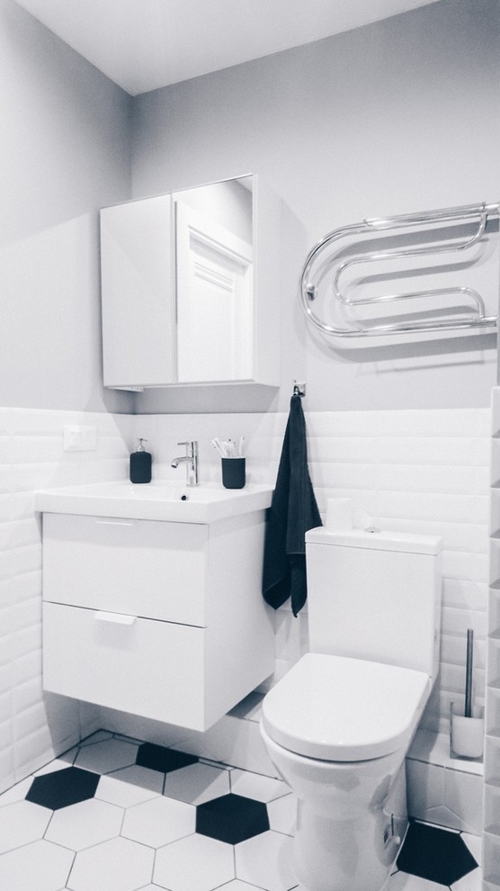This is an example of a scandinavian 3/4 bathroom in Moscow with white cabinets, an alcove shower, white tile, white walls, white floor and a shower curtain.