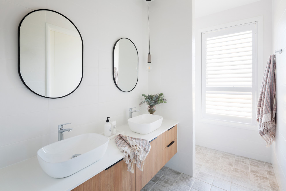 This is an example of a mid-sized 3/4 bathroom in Canberra - Queanbeyan with a one-piece toilet, white tile, porcelain tile, porcelain floors, a vessel sink, engineered quartz benchtops, an open shower, white benchtops, a double vanity and a built-in vanity.