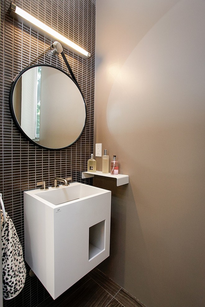 Photo of a contemporary powder room in Los Angeles with white cabinets, brown tile and brown walls.
