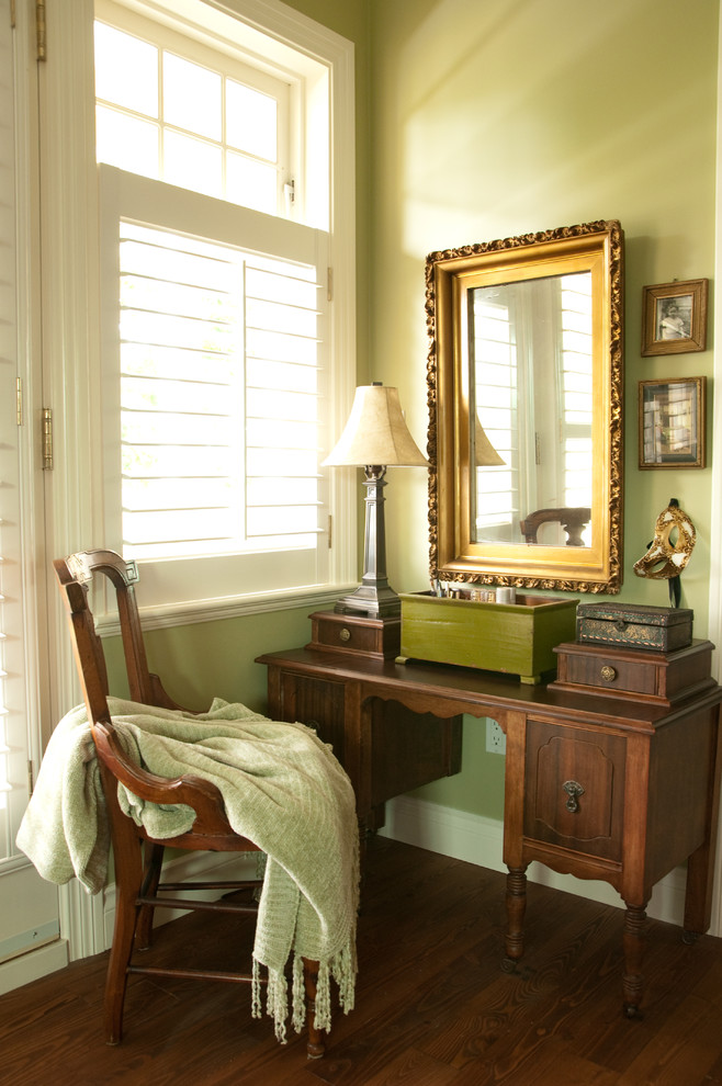 Photo of a traditional bedroom in Vancouver with green walls and medium hardwood floors.