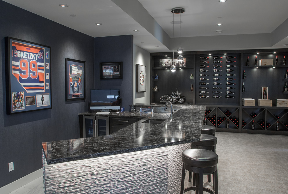 This is an example of a transitional seated home bar in Vancouver with an undermount sink, carpet and grey floor.