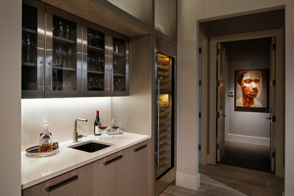 Design ideas for a contemporary single-wall wet bar in Miami with an undermount sink and glass-front cabinets.