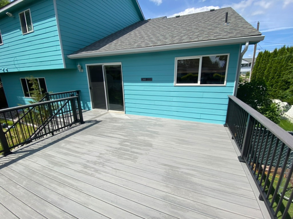 Deck - large backyard metal railing deck idea in Seattle