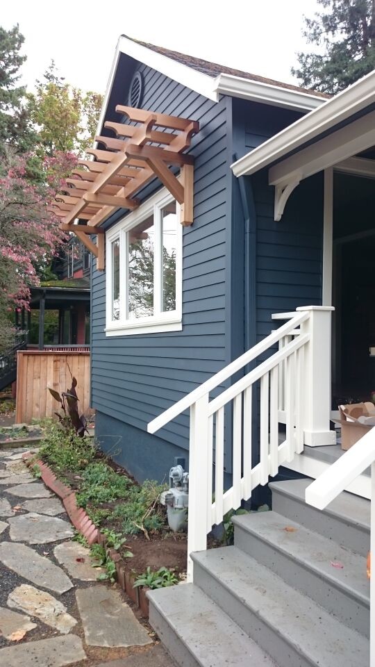 This is an example of a mid-sized contemporary two-storey blue house exterior in Portland with a gable roof and a shingle roof.