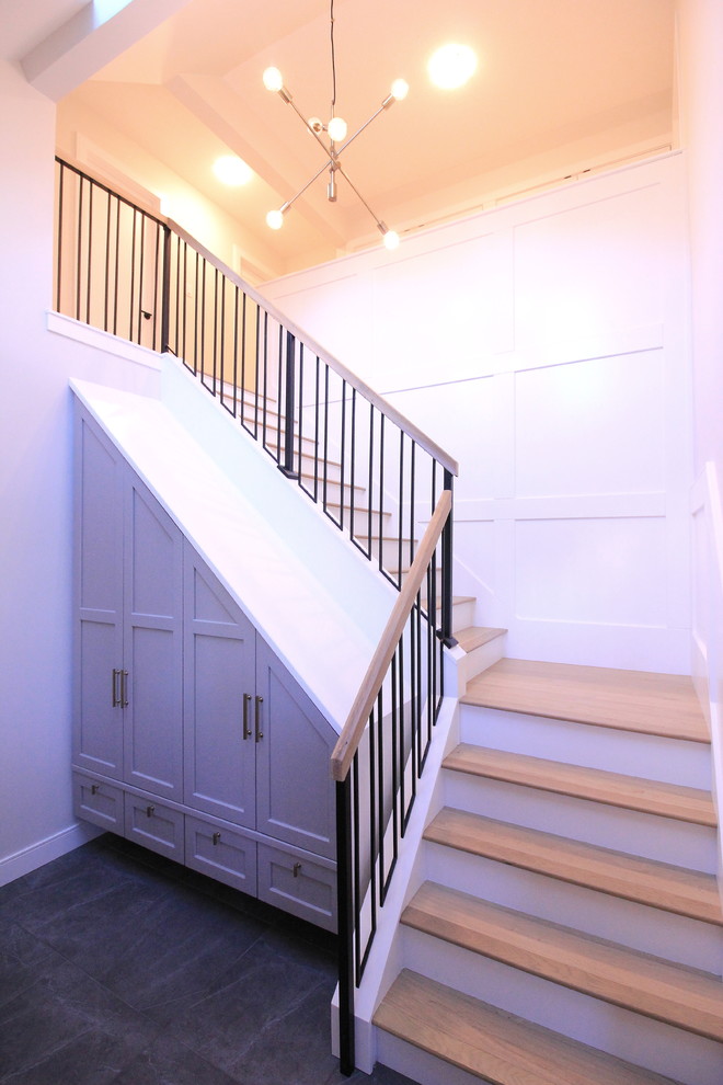 Example of a large transitional wooden l-shaped mixed material railing staircase design with painted risers
