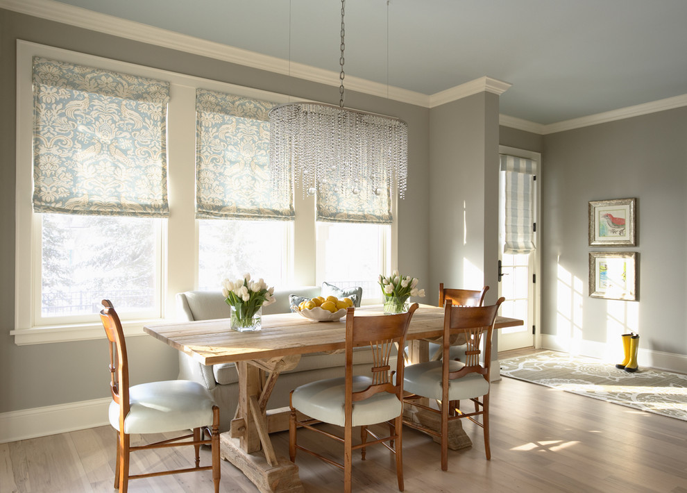Photo of a traditional dining room in Minneapolis with grey walls and light hardwood floors.