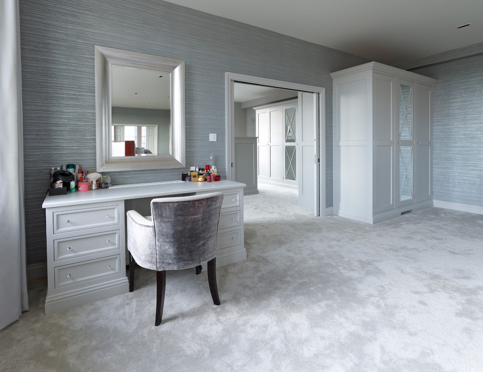 Large contemporary gender-neutral dressing room in Hertfordshire with recessed-panel cabinets, grey cabinets and carpet.