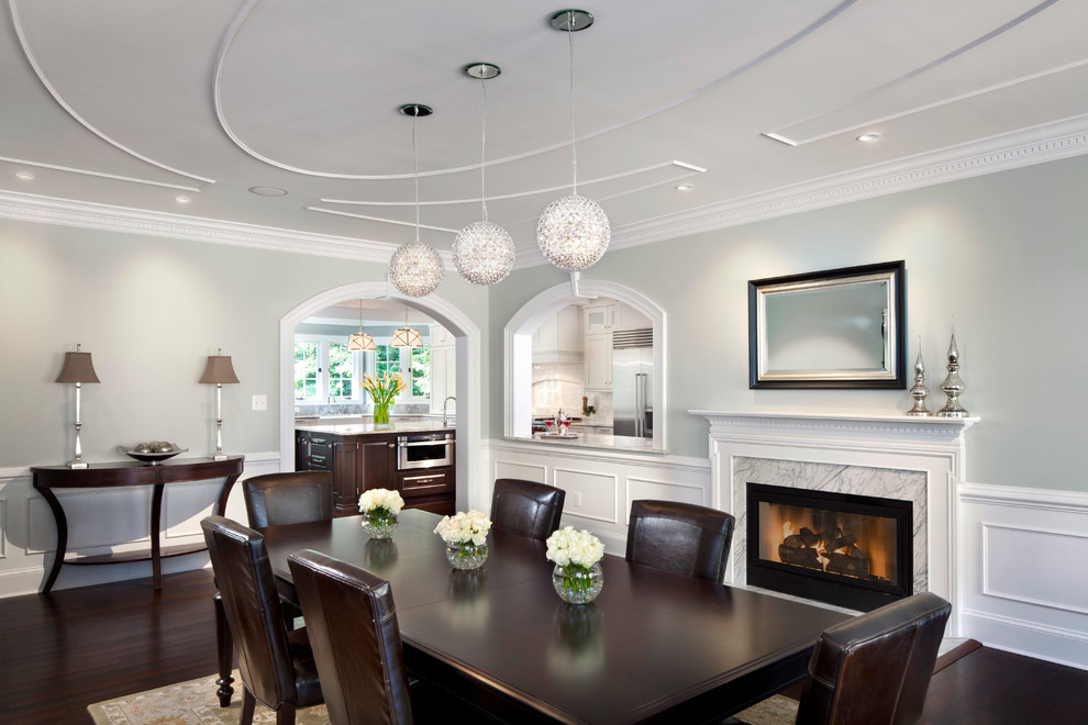 Expansive traditional separate dining room in DC Metro with grey walls, dark hardwood floors, a standard fireplace and a stone fireplace surround.