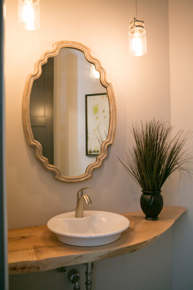 Inspiration for a rustic bathroom remodel with a vessel sink, wood countertops and beige countertops