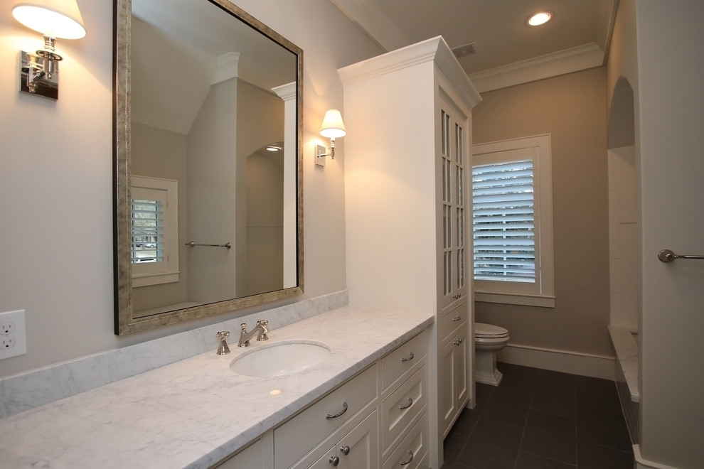 Photo of a mid-sized traditional 3/4 bathroom in Houston with furniture-like cabinets, an undermount tub and a drop-in sink.